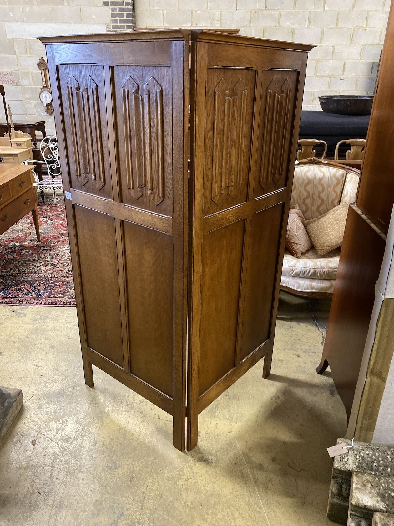 A linenfold moulded oak two fold dressing screen, each panel width 73cm, height 170cm